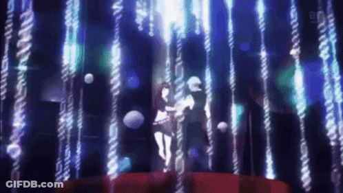 A Man And Woman Are Dancing In A Dark Room GIF
