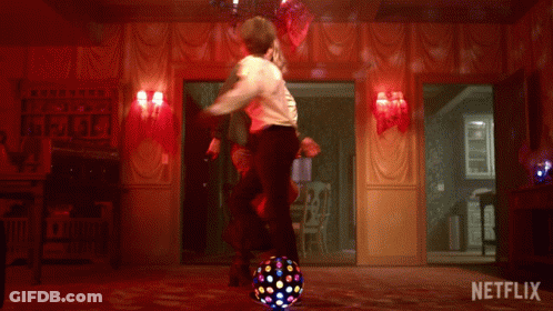 A Man And Woman Are Dancing In A Room With A Netflix Logo On The Bottom GIF
