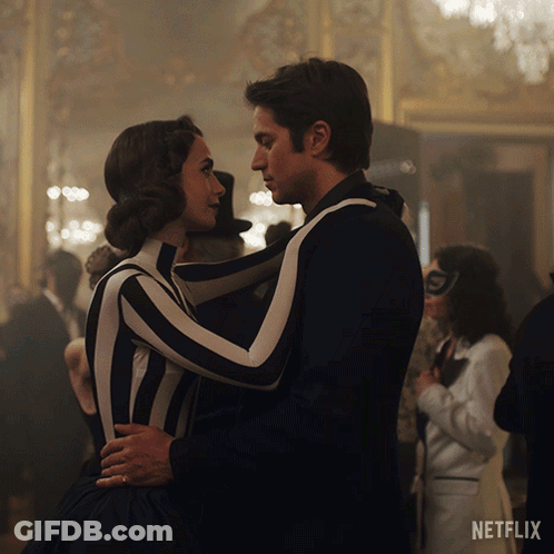 A Man And Woman Are Dancing In Front Of A Netflix Ad GIF