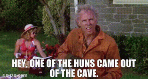 A Man And Woman Are Having A Picnic In The Grass And The Man Is Saying Hey One Of The Huns Came Out Of The Cave GIF
