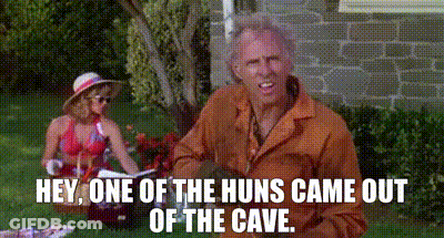 A Man And Woman Are Having A Picnic In The Grass And The Man Is Saying Hey One Of The Huns Came Out Of The Cave GIF
