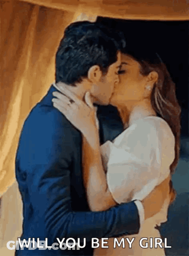 A Man And Woman Are Kissing And The Man Is Asking The Woman If She Will Be His Girl . GIF