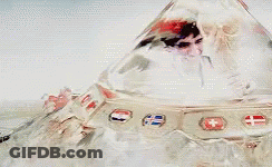 A Man And Woman Are Kissing In A Futuristic Space Ship . GIF