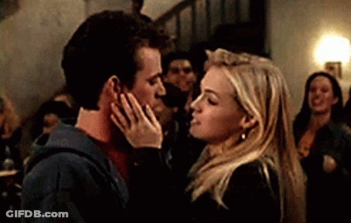 Kissing Couple In Front Of Crowd GIF