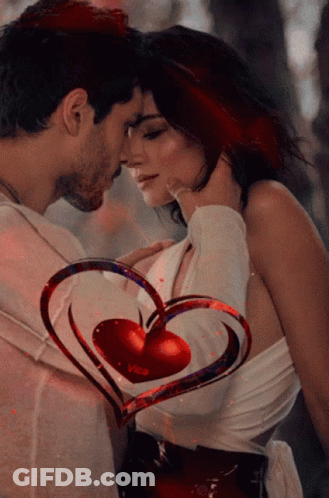 A Man And Woman Are Kissing With A Heart That Says Vica On It GIF