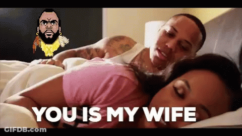 A Man And Woman Are Laying In Bed And The Woman Is Saying You Is My Wife . GIF