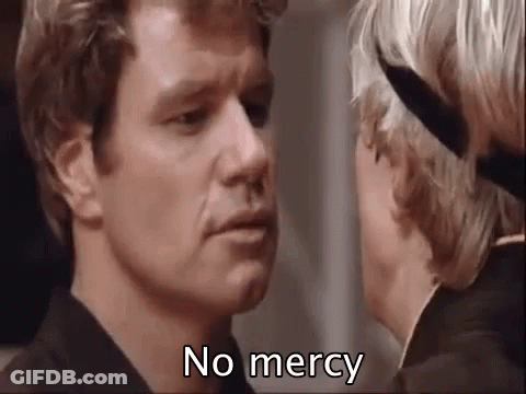 A Man And Woman Are Looking At Each Other And The Man Is Saying `` No Mercy '' . GIF