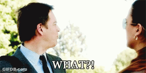 A Man And Woman Are Looking At Each Other And The Man Is Saying " What " GIF