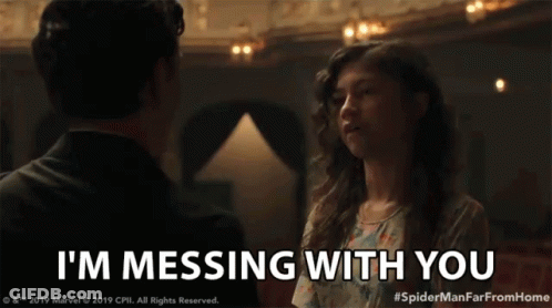 A Man And Woman Are Looking At Each Other And The Woman Is Saying I 'M Messing With You GIF