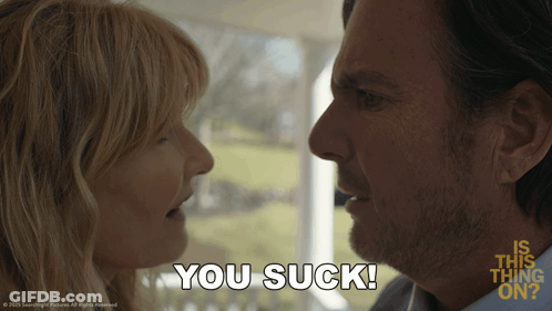 A Man And Woman Are Looking At Each Other And The Woman Says You Suck GIF