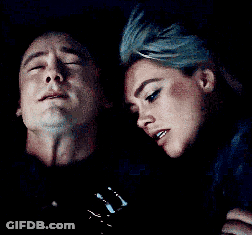 A Man And Woman Are Looking At Each Other In The Dark GIF