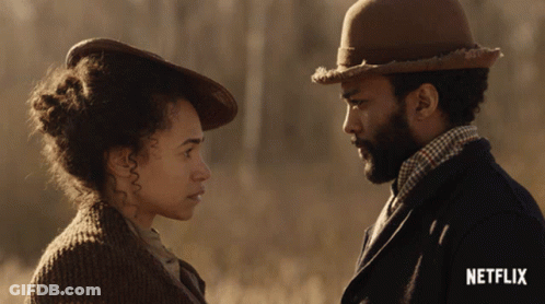A Man And Woman Are Looking At Each Other With A Netflix Logo In The Corner GIF