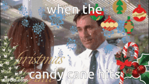 A Man And Woman Are Looking At Each Other With Candy Canes In The Background GIF