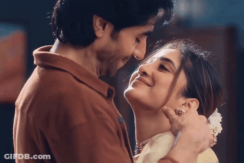 A Man And Woman Are Looking Into Each Other 'S Eyes And Smiling GIF