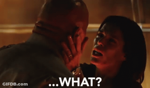 A Man And Woman Are Looking Into Each Other 'S Eyes And The Woman Is Saying " What " GIF
