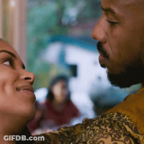 A Man And Woman Are Looking Into Each Other 'S Eyes GIF