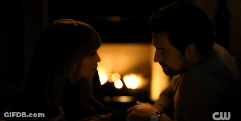A Man And Woman Are Looking Into Each Other 'S Eyes With A Cw Logo In The Background GIF