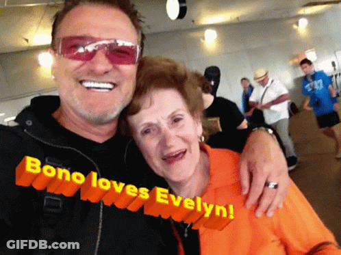 A Man And Woman Are Posing For A Picture And The Caption Says Bono Loves Evelyn GIF