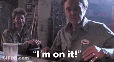 A Man And Woman Are Sitting At A Table And The Man Is Saying I 'M On It GIF