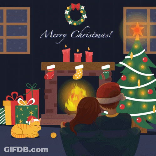 A Man And Woman Are Sitting In Front Of A Fireplace And A Christmas Tree GIF
