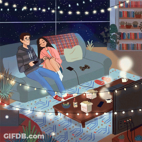 A Man And Woman Are Sitting On A Couch Playing A Video Game GIF
