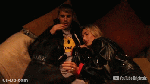 A Man And Woman Are Sitting On A Couch With Youtube Originals In The Corner GIF