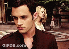 A Man And Woman Are Standing Next To Each Other GIF