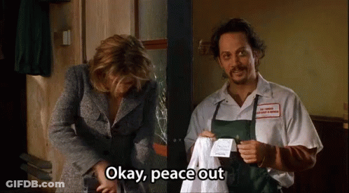 A Man And Woman Are Standing Next To Each Other And The Man Is Holding A Piece Of Paper That Says Okay Peace Out GIF
