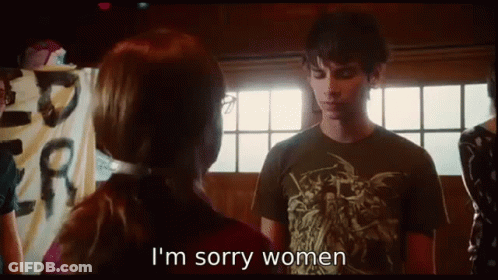 A Man And Woman Are Standing Next To Each Other And The Woman Is Saying I 'M Sorry Women . GIF