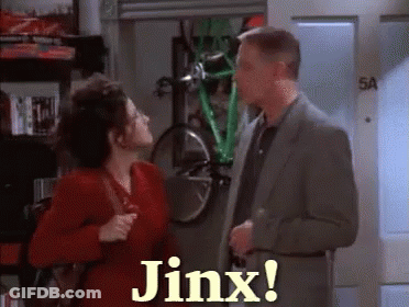 A Man And Woman Are Standing Next To Each Other And The Woman Is Saying Jinx GIF