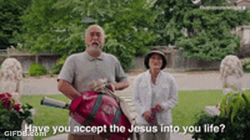 A Man And Woman Are Standing Next To Each Other In A Park And The Man Is Holding A Golf Bag . GIF