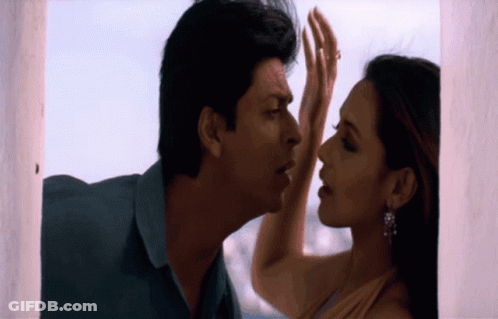 A Man And Woman Are Touching Each Other 'S Foreheads GIF
