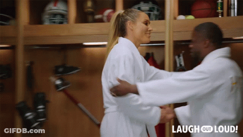 A Man And Woman Hugging In A Locker Room With Laugh Out Loud Written On The Bottom Right GIF