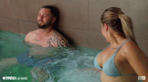 A Man And Woman In A Hot Tub With The Hashtag Mafs On The Bottom GIF