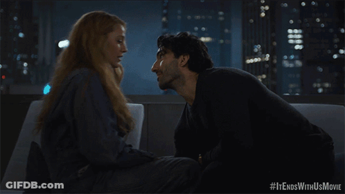 A Man And Woman Kissing On A Couch With #It Ends With Us Movie Written Below Them GIF