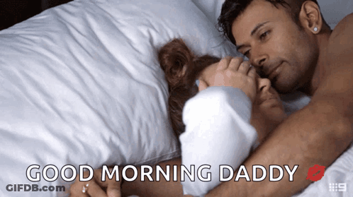 A Man And Woman Laying In Bed With The Words Good Morning Daddy GIF
