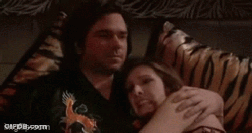 A Man And Woman Laying On A Bed With The Words Oh Goooood Written Above Them GIF