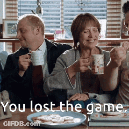 A Man And Woman Sitting At A Table With The Words You Lost The Game Written Below Them GIF