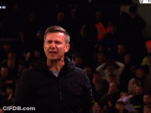 A Man Applauds In Front Of A Crowd With The Time 4:11 GIF