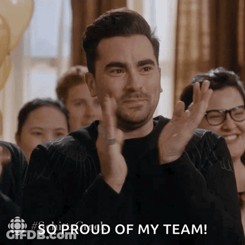 A Man Applauds With The Words So Proud Of My Team Above Him GIF