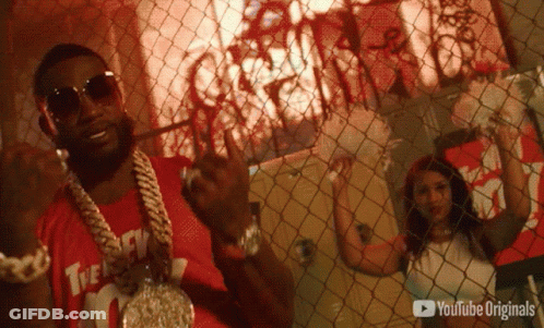 A Man Behind A Chain Link Fence With A Youtube Originals Logo GIF