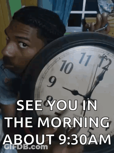 A Man Behind A Clock That Says " See You In The Morning About 9:30Am " GIF