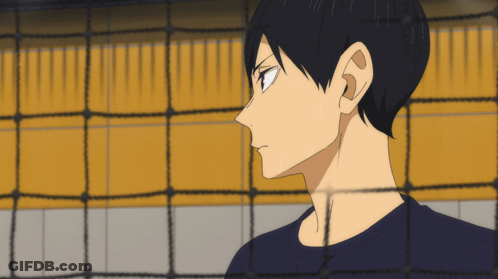 A Man Behind A Volleyball Net Looks At Something GIF