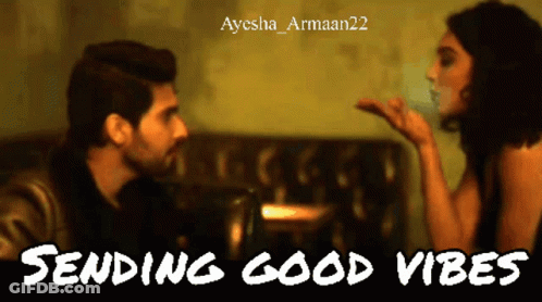 A Man Blowing A Kiss To A Woman With The Words Sending Good Vibes Below Him GIF
