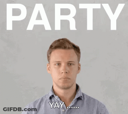 A Man Blowing Confetti In Front Of A Sign That Says Party GIF