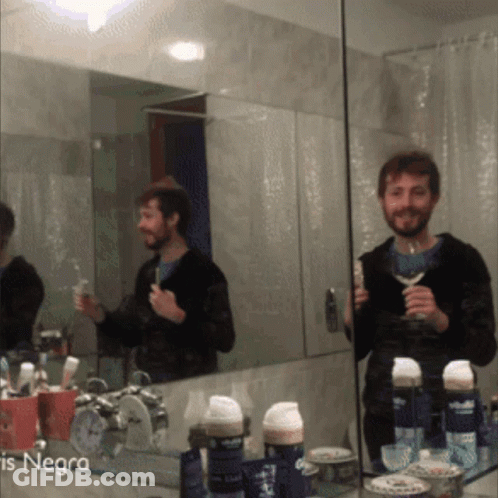 A Man Brushing His Teeth In Front Of A Mirror With The Word Negra On The Bottom Left GIF