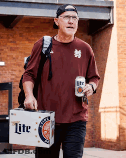 A Man Carrying A Box Of Lite Beer And A Can Of Beer GIF