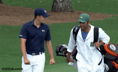 A Man Carrying A Golf Bag Has The Number 80 On His Shirt GIF