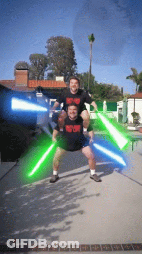A Man Carrying Another Man On His Shoulders Is Wearing A Shirt That Says Heavy Metal GIF