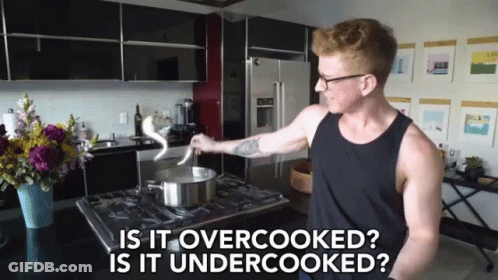 A Man Cooking In A Kitchen With The Words " Is It Overcooked Is It Undercooked " Above Him GIF